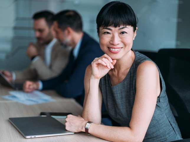 Confident professional smiling at a conference table